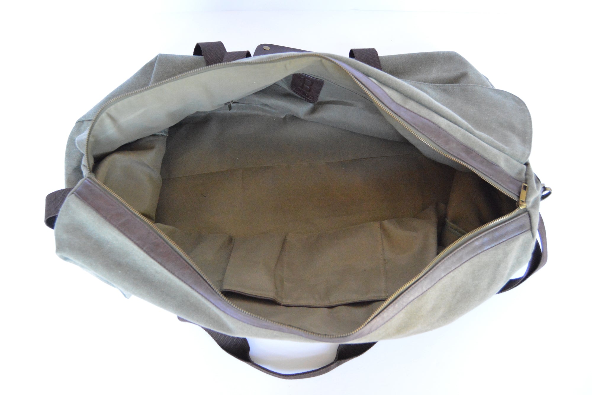 Bellemonde washed green canvas Briefcase shown from above and open with interior compartments